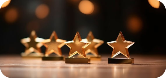 closeup golden star trophies wooden surface with blurred