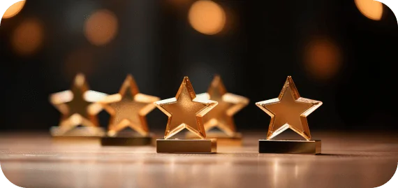 closeup golden star trophies wooden surface with blurred